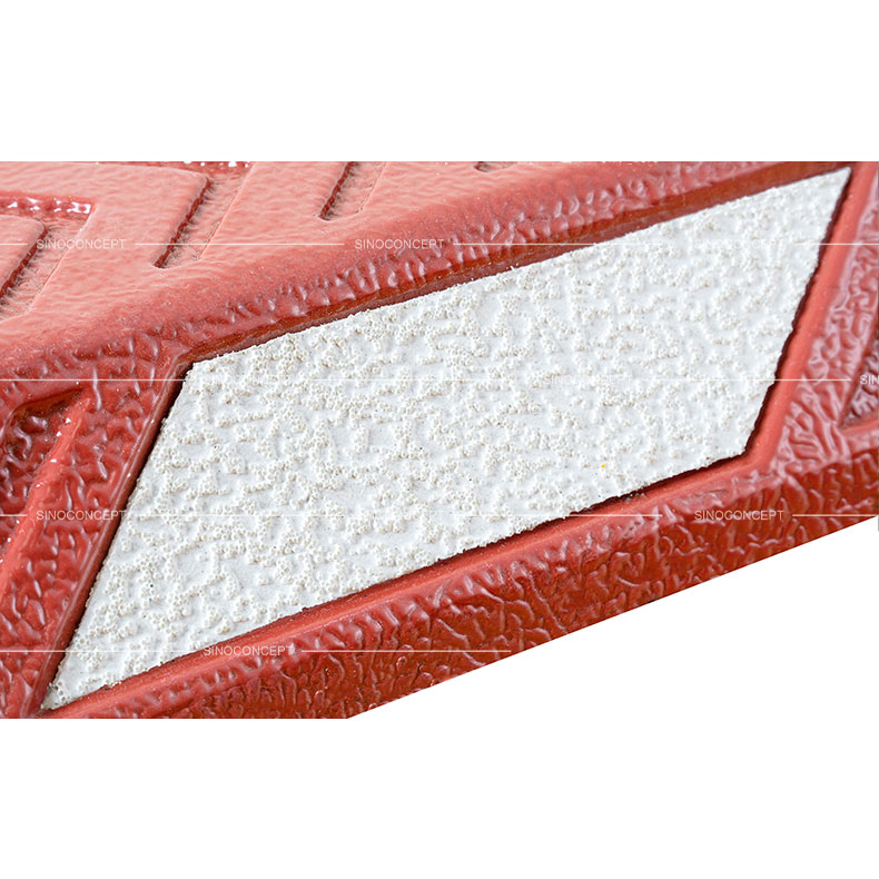Red cycle lane dividers made of plastic-rubber composite, embedded with white thermoplastic reflective road marking films for enhancing visibility.