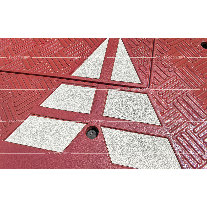 Red speed table with anti-slipe stripes design on the surface and white reflective films used as traffic calming devices