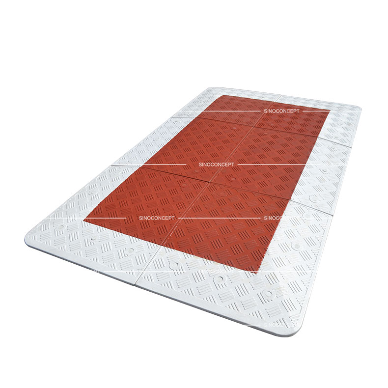 A red and white 6-part Belgium style speed cushion made of vulcanised rubber for traffic-calming purposes.