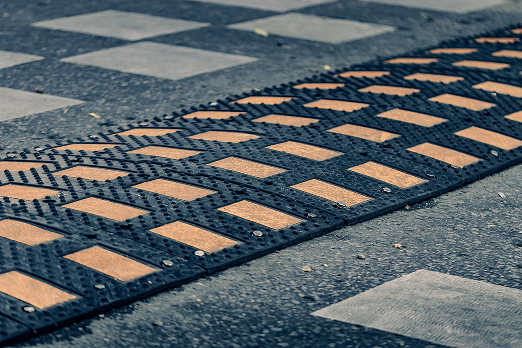 Black speed humps composed of many small parts used on the road to reduce traffic speed