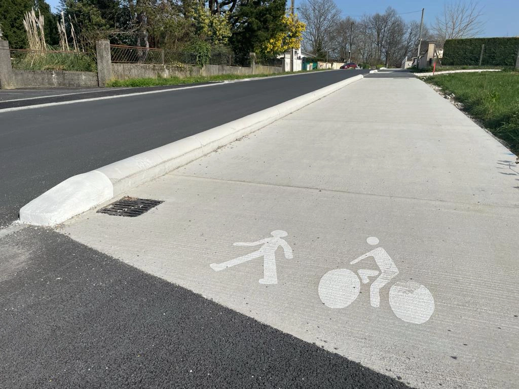 Concrete cycle lane dividers and white road markings for better traffic management
