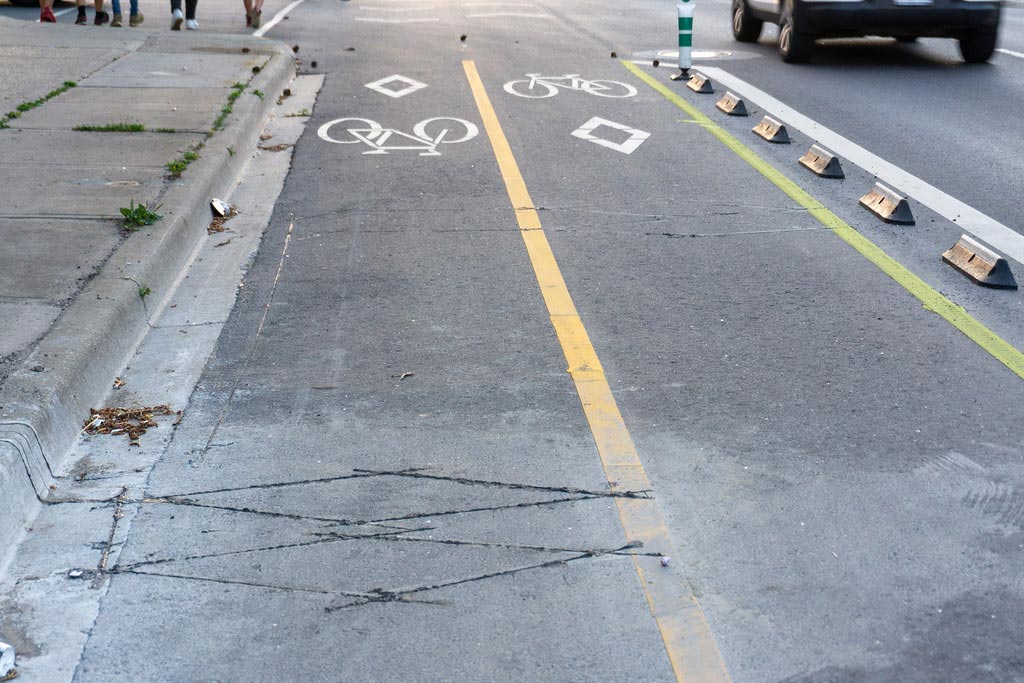 Cycle lane separator curbs installed in a line together with road markings to indicate cycle lanes