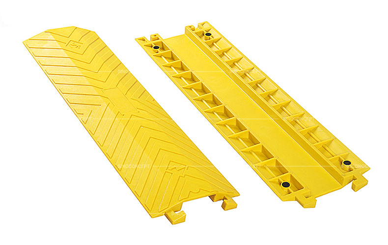 Large yellow drop over cable protectors made of polyurethane designed with skidproof surface and four black anti-slip pads