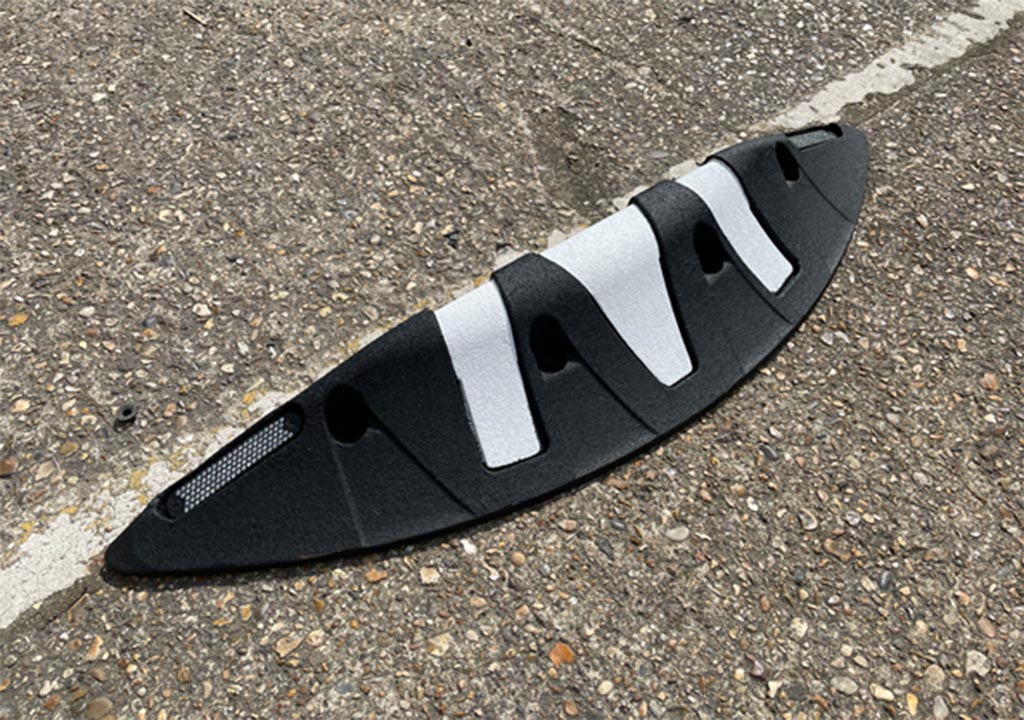 Black ORCA lane separator with white stripes to reminde road users for traffic safety