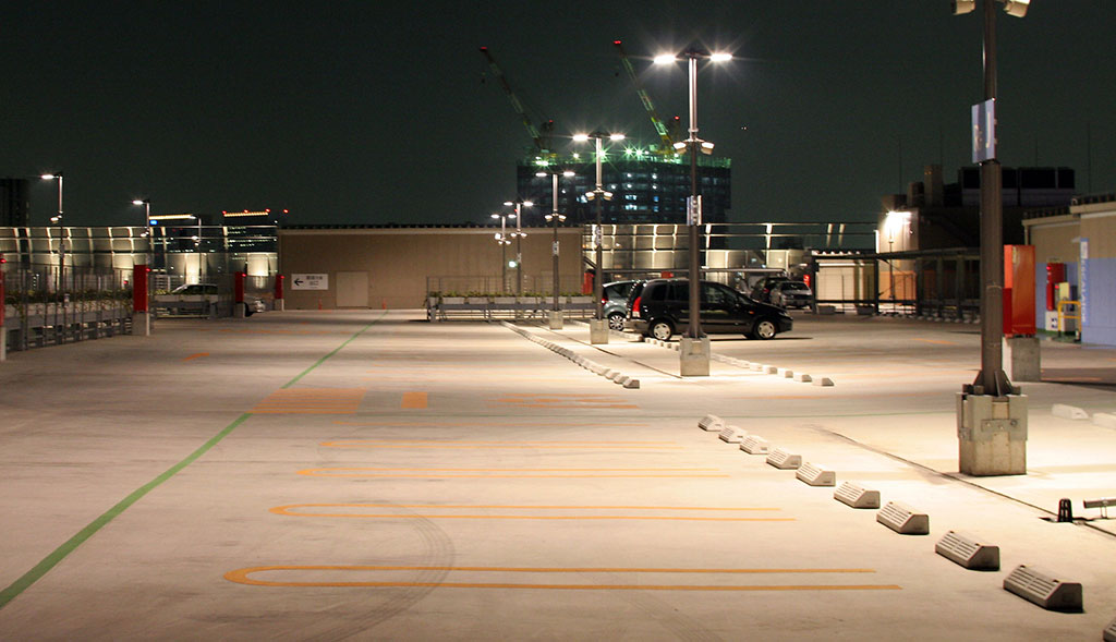 Parking curbs are installed in an outdoor parking lot to stop further movement of parking vehicles