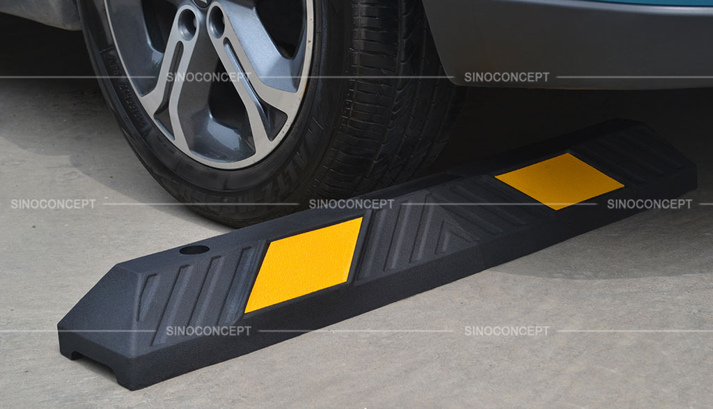 Sino Concept wheel stopper made of recycled rubber and pasted with yellow reflective tapes.