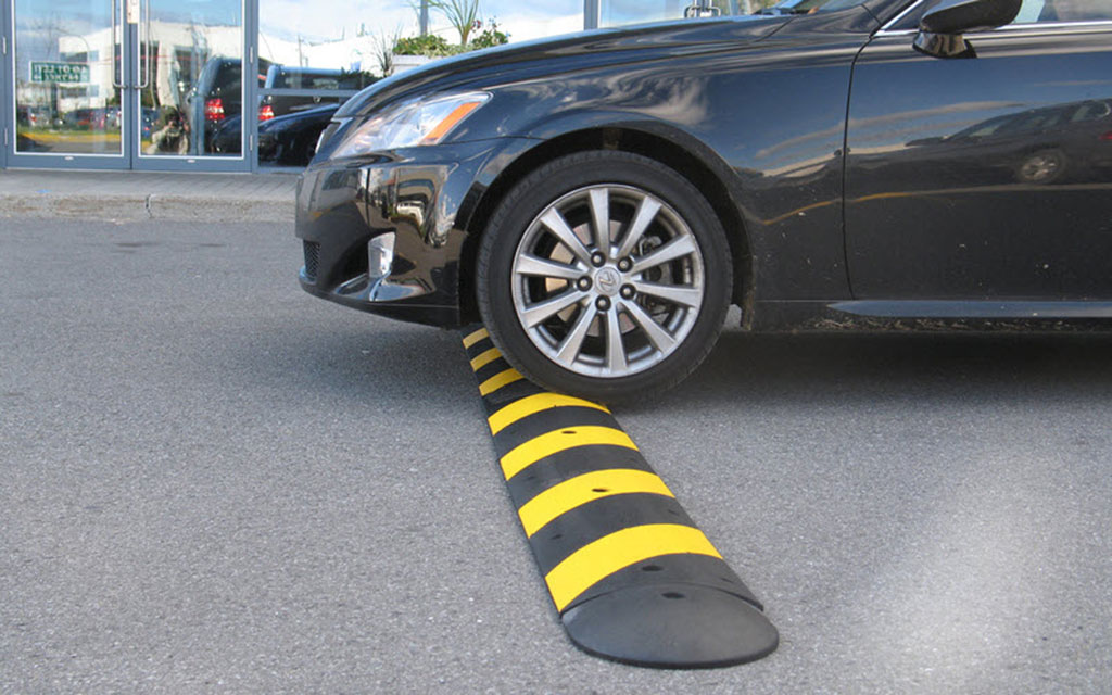 Black and yellow speed breaker made by Checkers used for reducing traffic speed