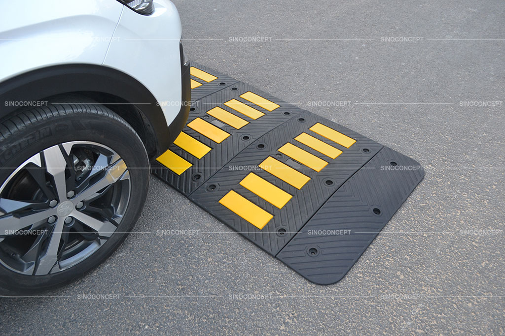 A rubber speed hump designed with arrow surfaces and yellow tapes for better traffic management