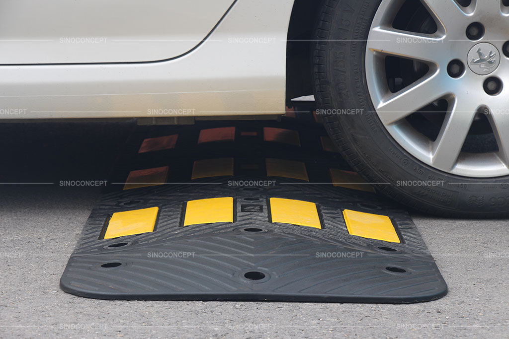 Traffic speed hump made of vulcanized rubber, coloured in black with yellow reflective tapes for better traffic management