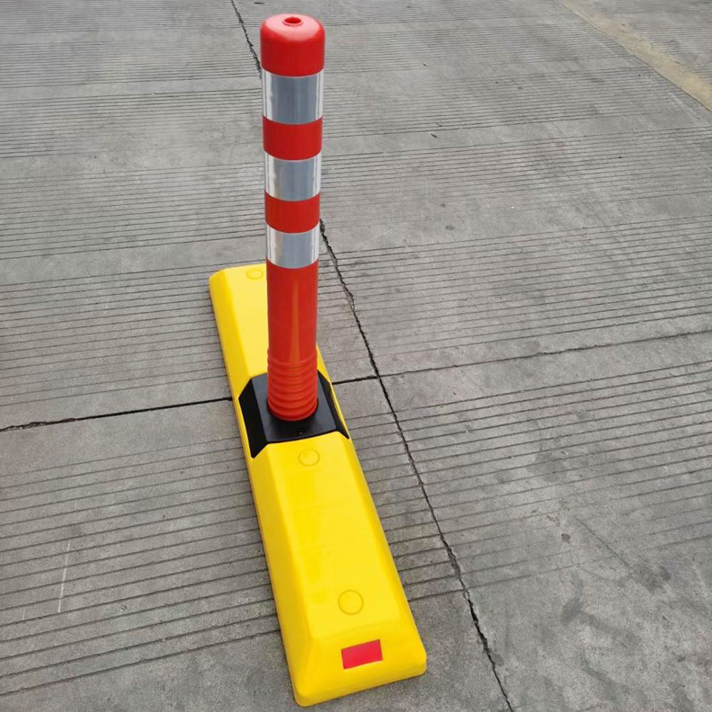 Yellow plastic lane divider with an orange post fixed on the base to make it more obvious for the road users