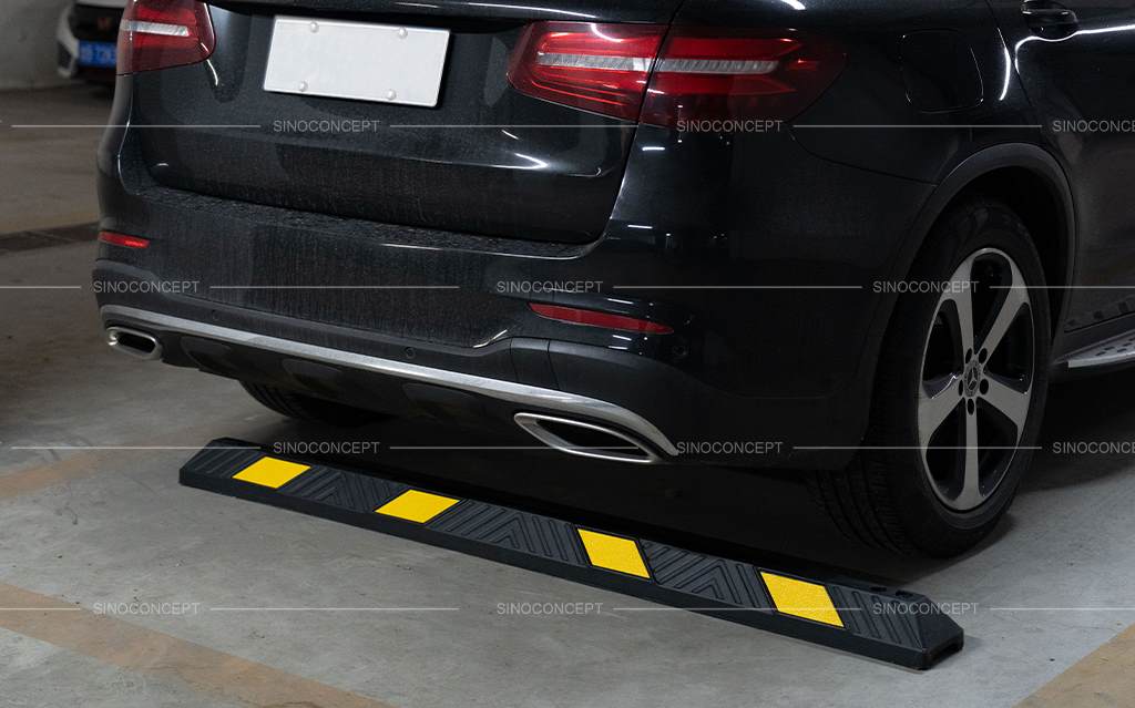 An 1830mm parking bumper, also called a car parking stopper, is made of black recycled rubber and yellow reflective tapes for car park management.
