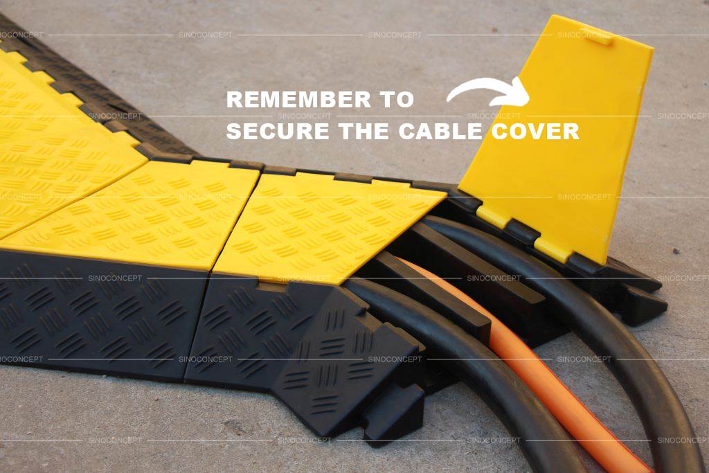 A 3-channel rubber cable ramp with yellow covers hides and protects electrical cords.