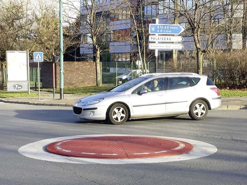 A red rubber roundabout in the middle of an intersection provides easy traffic diversion.