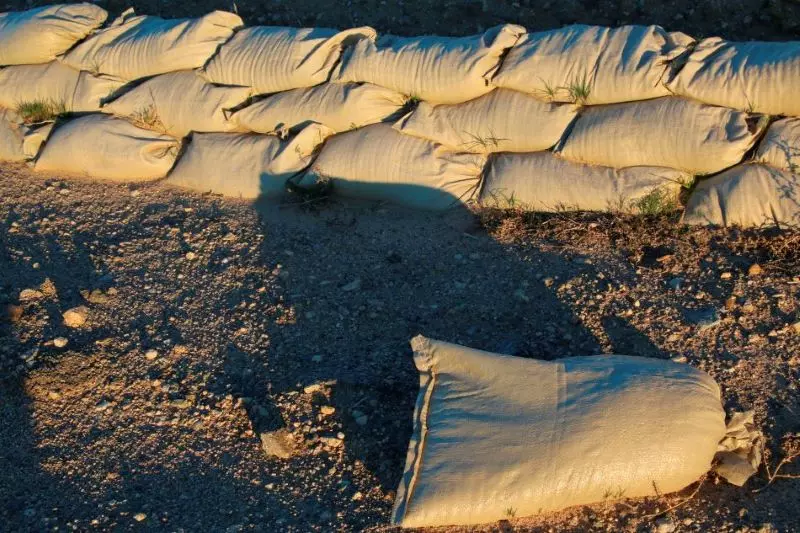 Many sandbags are placed together to stabilize soil from erosion.