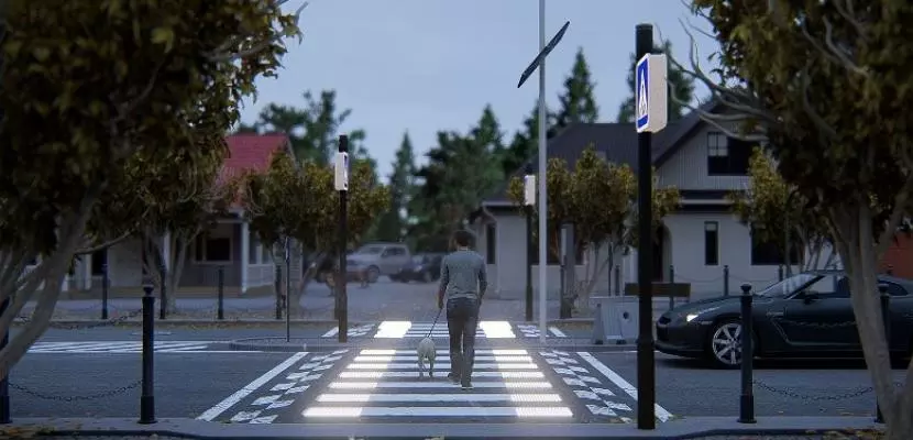 A man with a dog is crossing the intelligent crosswalks.