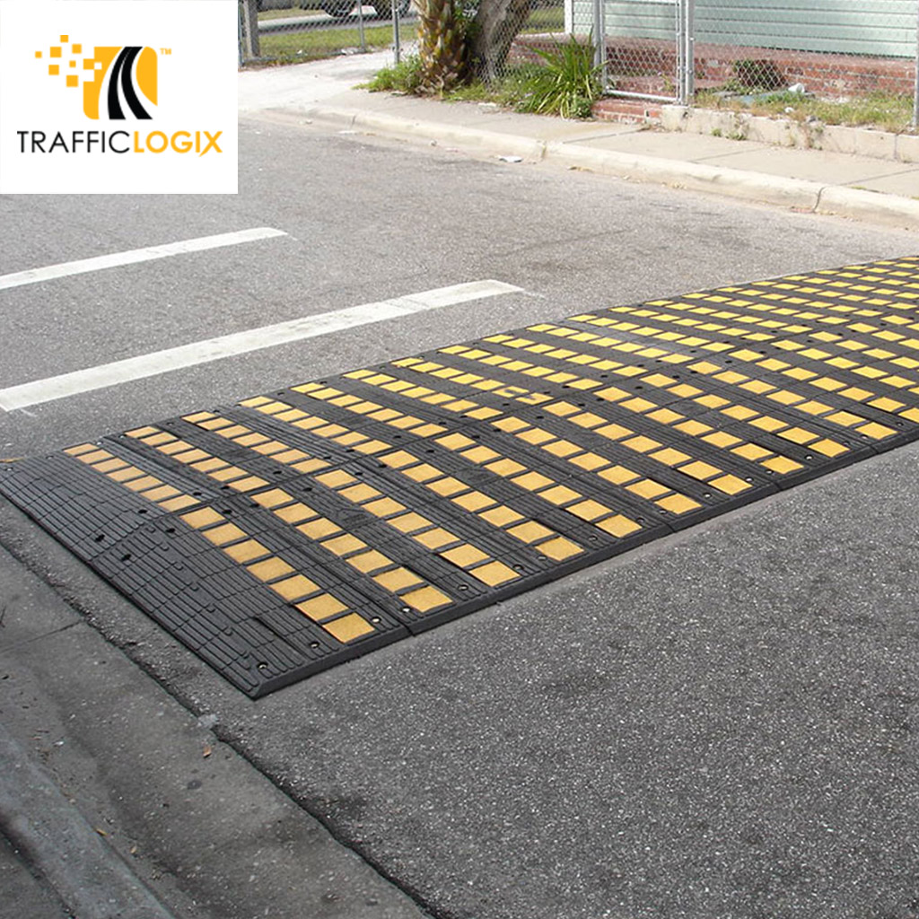 A big speed hump coloured in black and yellow, composed of many small parts for traffic calming