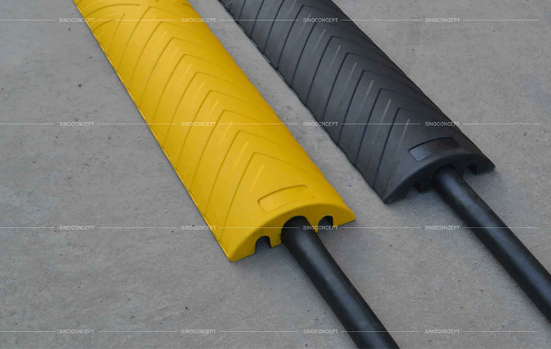 Black or yellow outdoor cable protectors also called cable ramps made of vulcanized rubber used for floor cable management