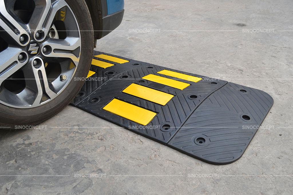 Black and yellow speed hump installed on the road to reduce vehicle speed