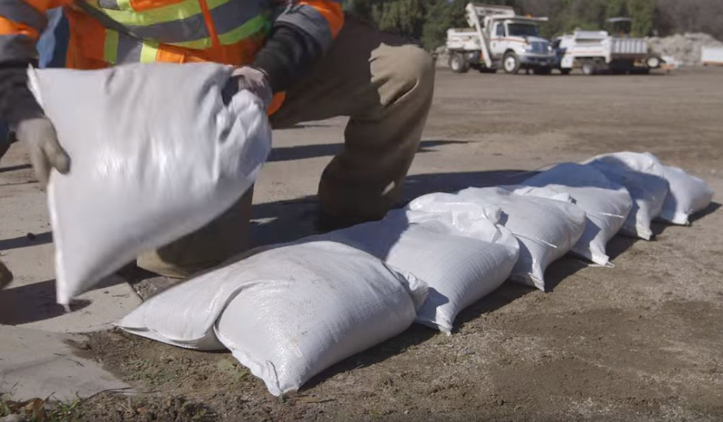 Filled sandbags coloured in white used to either for holding down traffic signs or to prevent floods