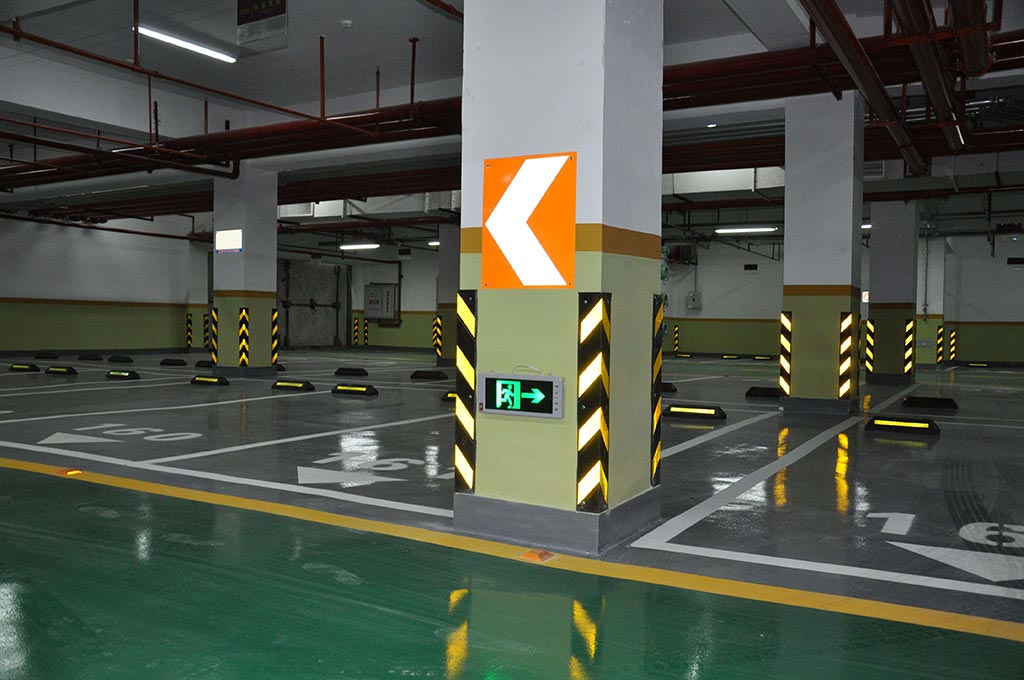 An indoor parking lot equipped with wheel stops and other traffic safety devices