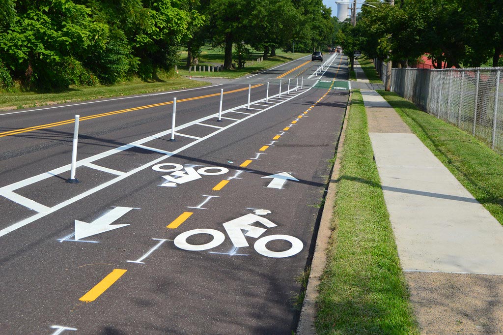 New desgied cycle lane with white road markings and white posts for the security of cyclists and motorists