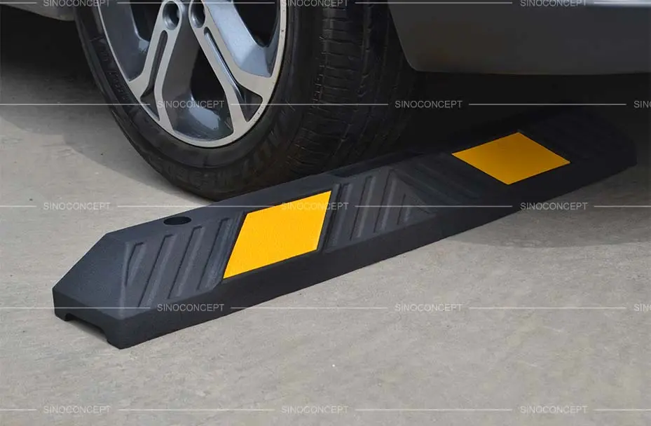 Black parking kerb pasted with yellow reflective films for better parking management.