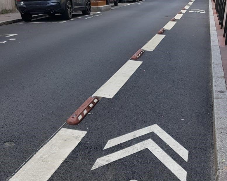 Red bike lane dividers installed on road to identify cycle lanes for the security of bicycle riders