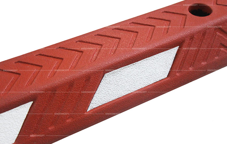 Red rubber cycle lane separator also called cycle lane divider made of vulcanized rubber showing rubber arrows design on the surface