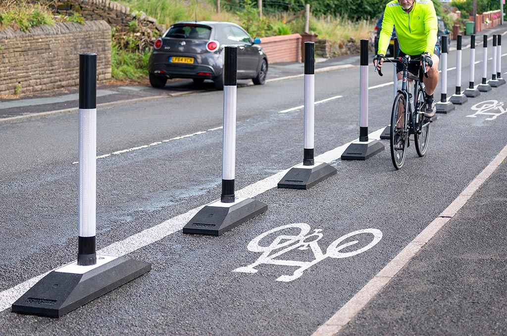 Black and white Rosehill cycle lane defenders with black and white posts inserted on the base for traffic management
