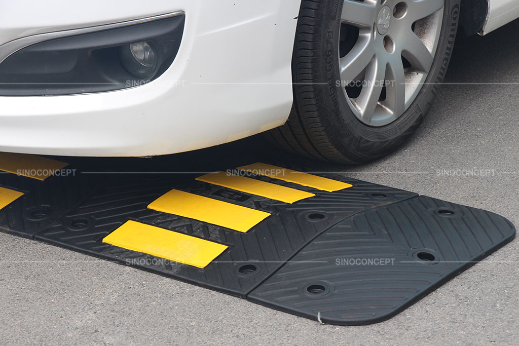 Black speed hump made of recycled rubber used for calming traffic purpose