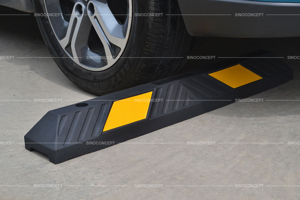 Black wheel stop made of vulcanized rubber, pasted with yellow films for better parking management