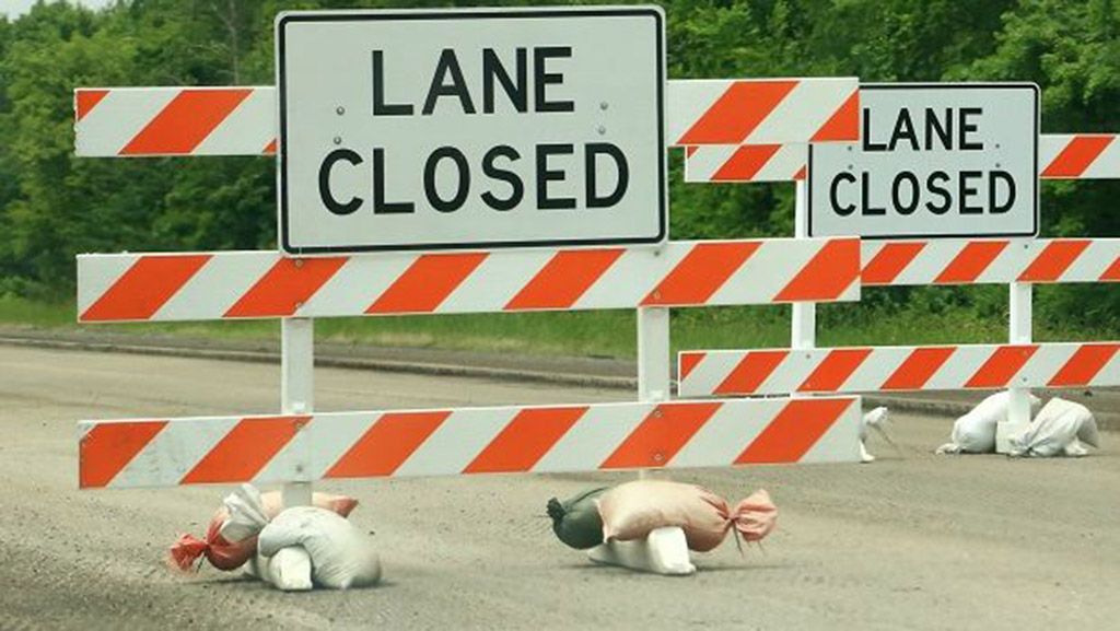 Some sandbags are used to stabilize road construction signs