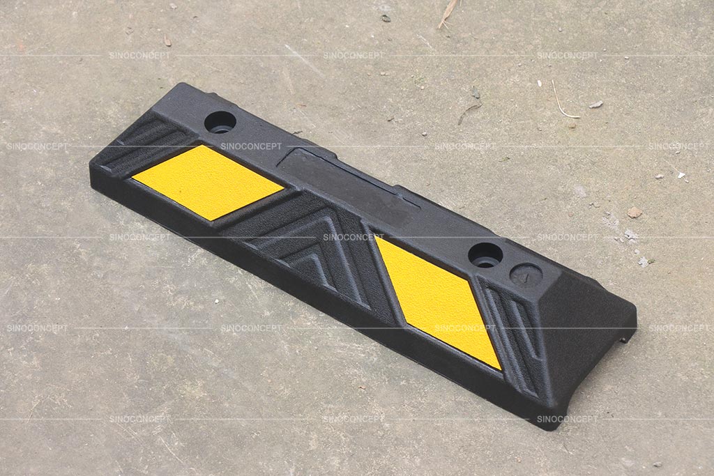 A short black wheel stopper pasted with yellow reflective film for parking safety use