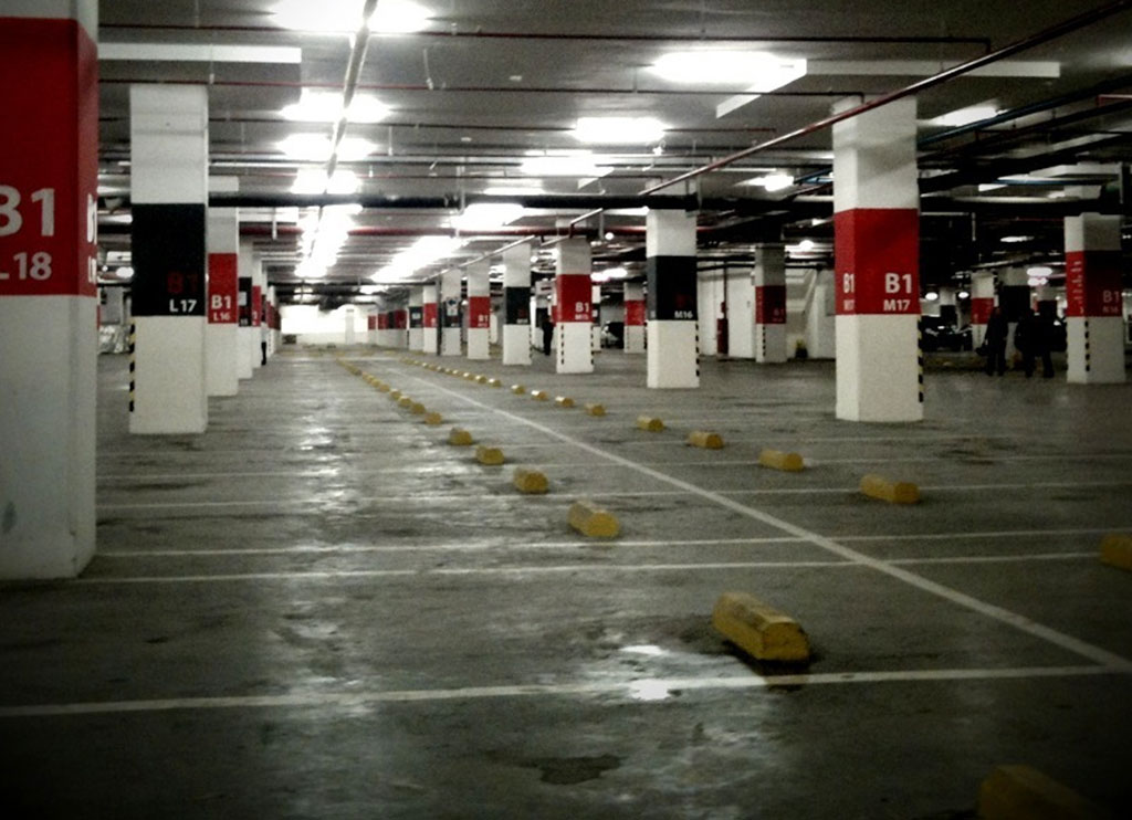 Yellow parking curbs installed in an indoor parking lot for efficient parking management