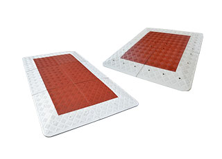 Belgium road cushions also called speed cushions made of red and white vulcanized rubber used in Belgium as a traffic calming device