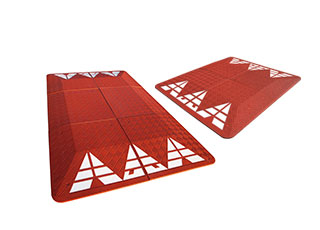 Red rubber speed cushion also called speed table made of red recycled rubber and white reflective tapes used for traffic calming