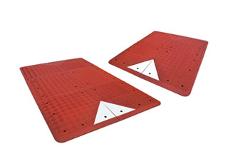 Red UK type speed tables made of vulcanized recycled rubber and white glass bead reflective tapes used for traffic calming purpose