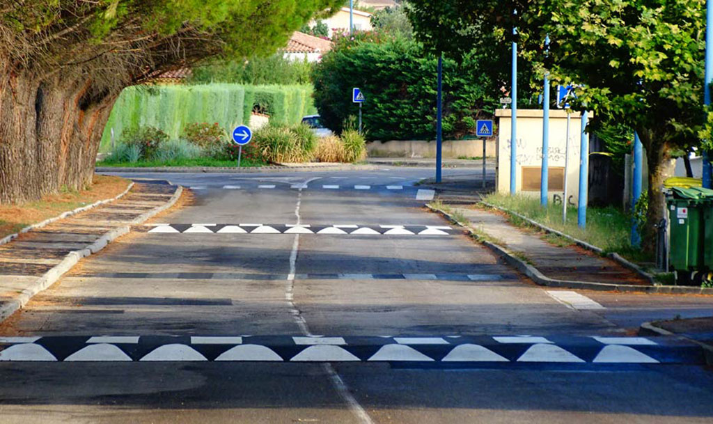 1-asphalt-speed-bumps Asphalt speed bumps installed on the road for traffic calming purpose
