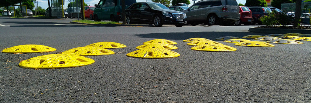 Small circular speed bumps with yellow colour and anti-slip surface used for traffic calming purpose