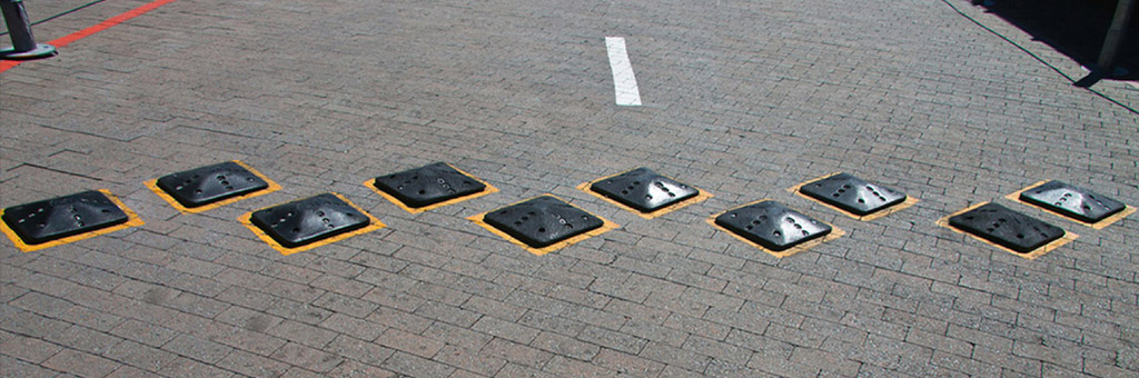 Small square speed bumps fixed on roads to reduce vehicle speed for traffic calming purpose