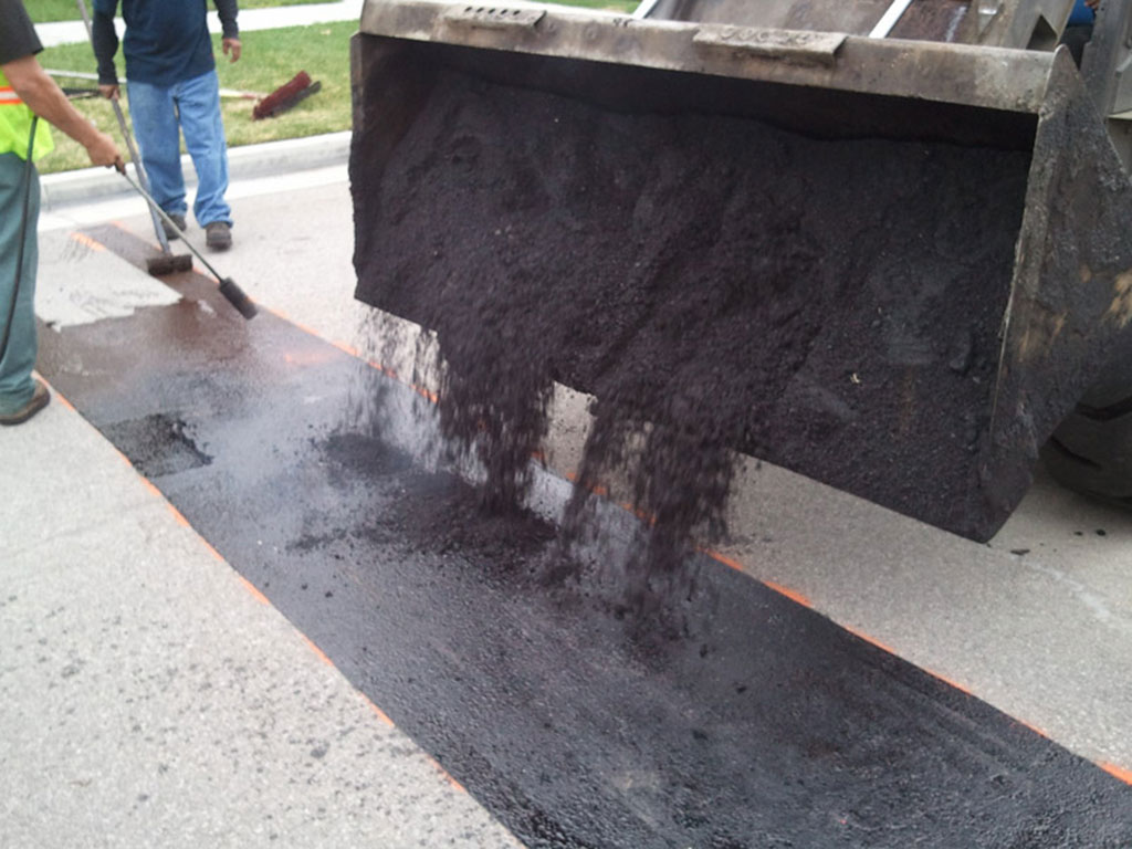 Some workers are making an asphalt speed bump