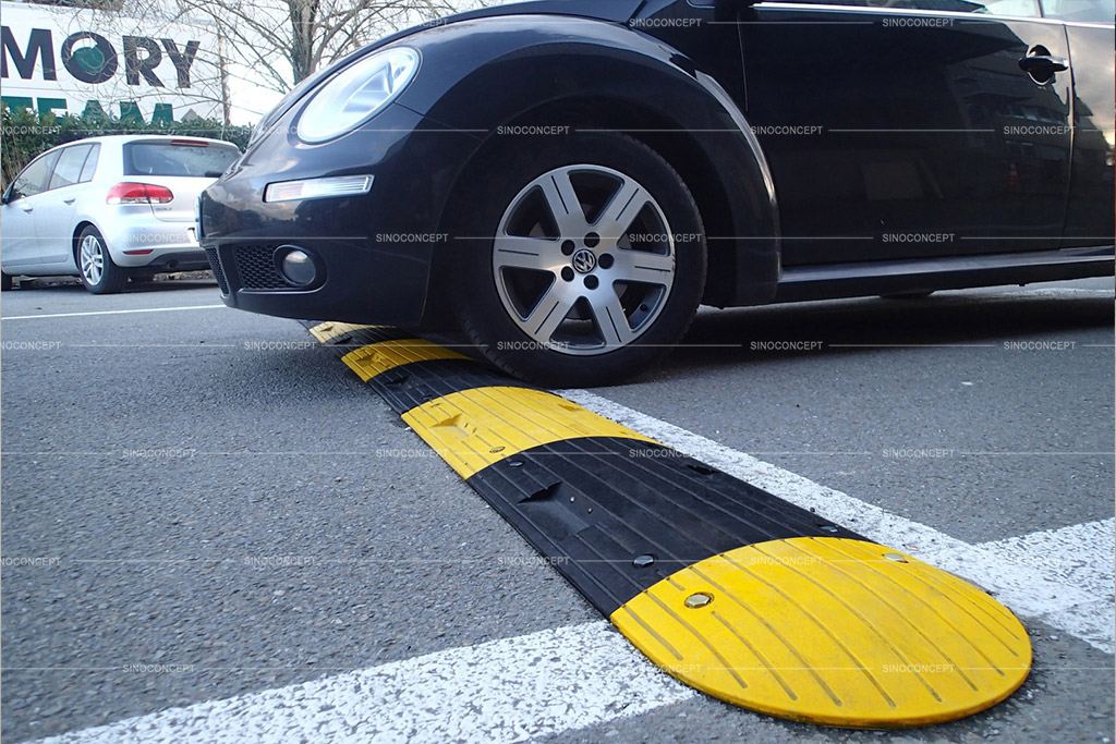 Black and yellow speed bump made of recycled rubber, put on the road to reduce the speed for vehicles