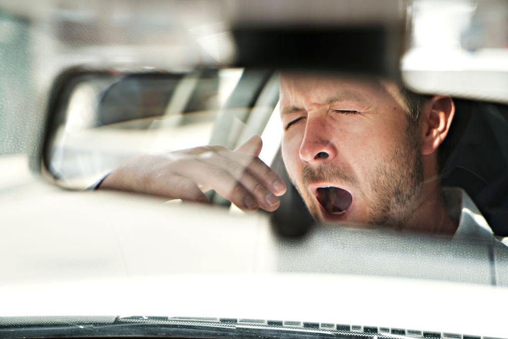 A sleepy driver who is driving a car