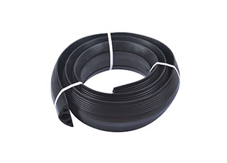 Black floor cord cover made of recycled rubber with three channels to receive one cable up to 40mm and two cables up to 20mm