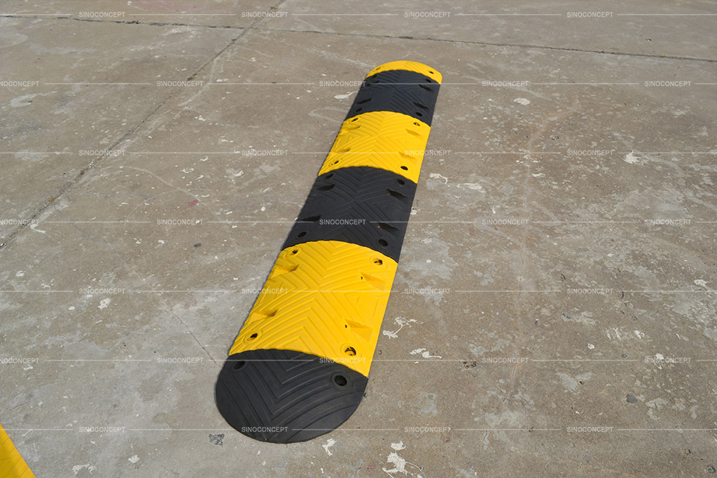 Safety speed ramp also called speed bump with black and yellow colours fixed to the ground for reducing vehicle speed