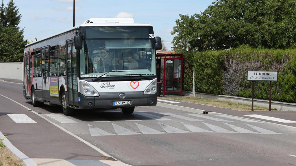 A bus is crossing an asphalt speed bump smoothly