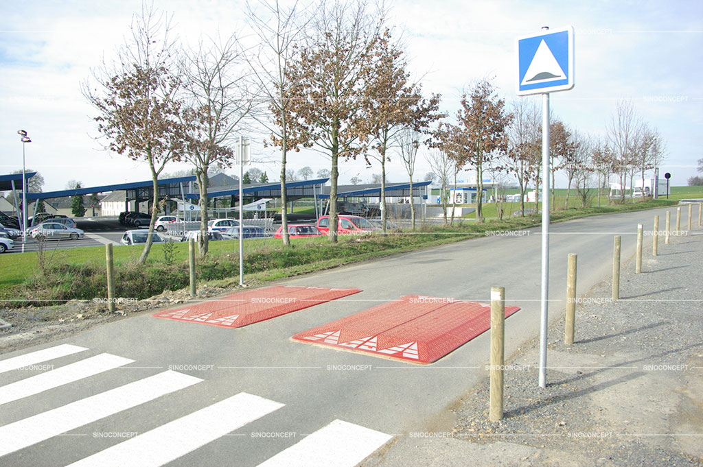 Two red speed cushions also called speed pillows pasted with white reflective films for traffic management