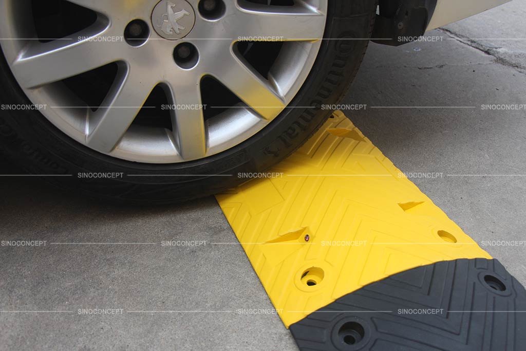 Car speed bump made of rubber with black and yellow colours as a traffic calming device
