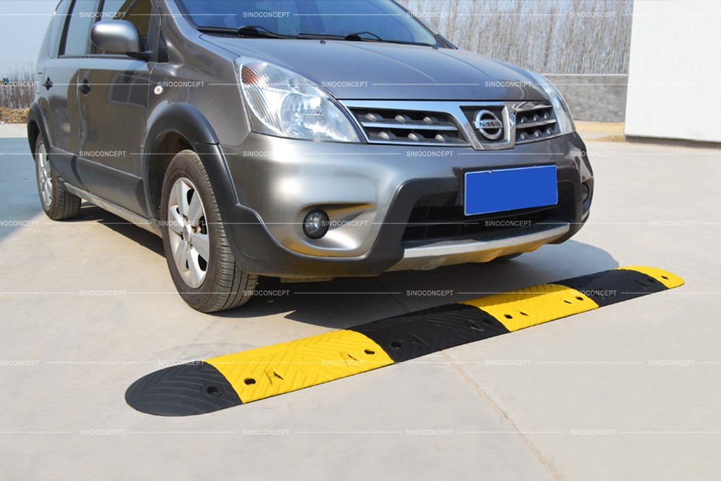 Speed breaker also called speed bump made of recycled rubber with cat-eye road studs for traffic calming purpose