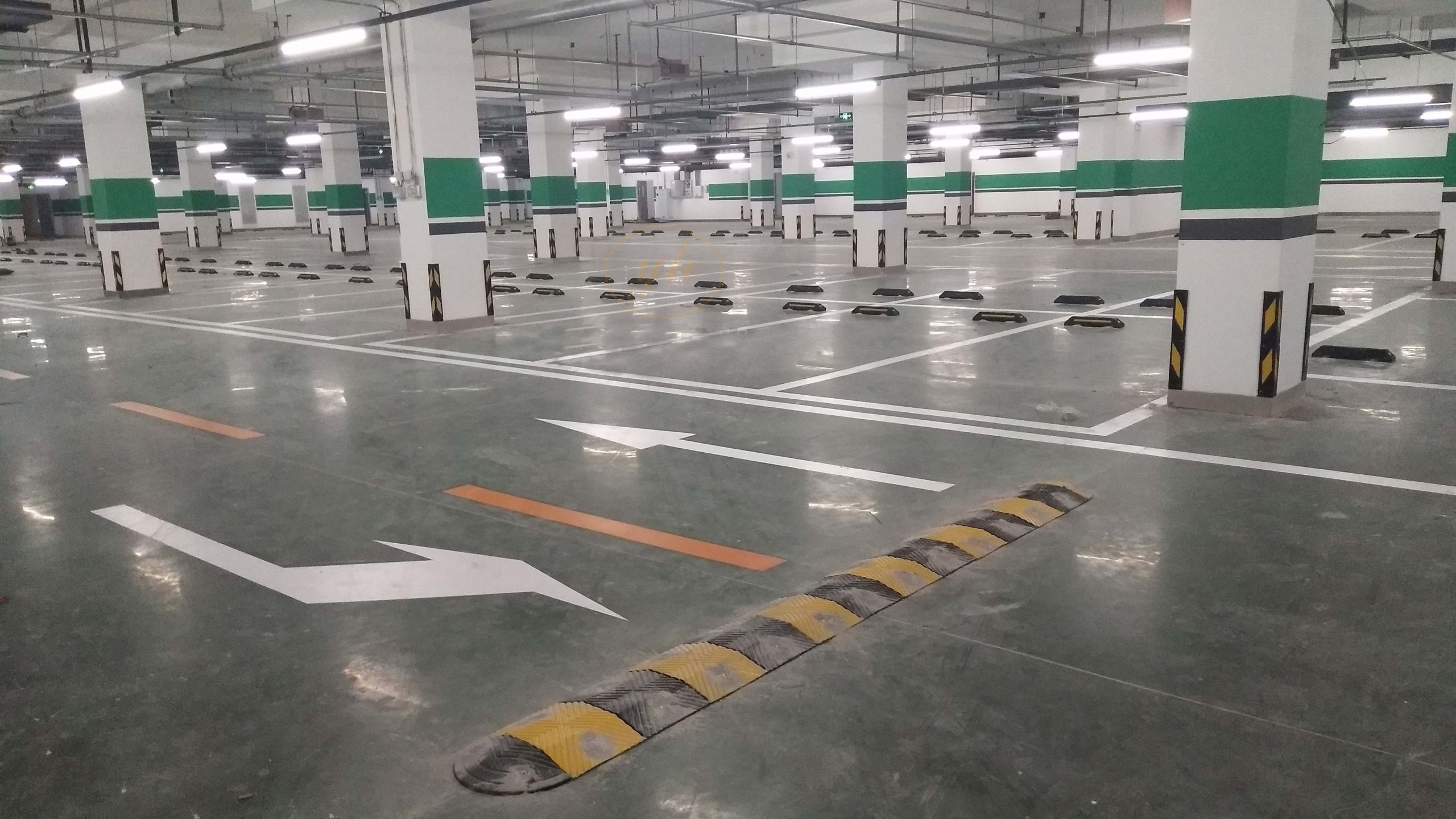 Parking lot devices include speed bump and wheel stops